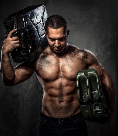 Muscular man with two metal fuel cans indoors Stock Photo - Budget Royalty-Free & Subscription, Code: 400-07747010