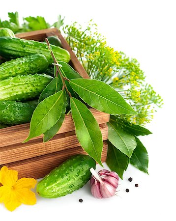 simsearch:400-07667021,k - Fresh cucumbers in wooden box with green leaf and flower. Isolated on white background Stock Photo - Budget Royalty-Free & Subscription, Code: 400-07747839