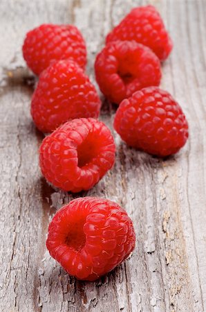 simsearch:400-08020671,k - Perfect Ripe Raspberries In a Row isolated on Rustic Wooden background Stock Photo - Budget Royalty-Free & Subscription, Code: 400-07747854