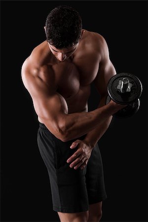 Portrait of a muscular man lifting weights against a dark background Stock Photo - Budget Royalty-Free & Subscription, Code: 400-07747976