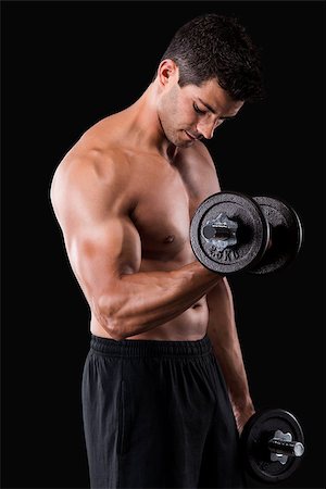 Portrait of a muscular man lifting weights against a dark background Stock Photo - Budget Royalty-Free & Subscription, Code: 400-07747971