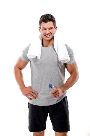 Portrait of a athletic man after doing exercises and holding a bottle of water, isolated over a white background Stock Photo - Budget Royalty-Free & Subscription, Code: 400-07748001