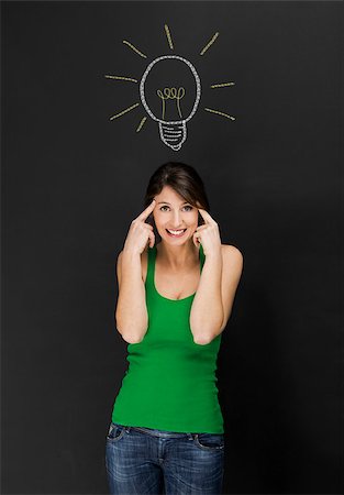 Beautiful young student having an idea, with lamp bulb designed on a chalkboard Stock Photo - Budget Royalty-Free & Subscription, Code: 400-07748011
