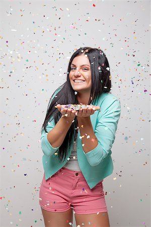 people celebrating new years eve - Young beautiful woman in party mood with confetti all around Stock Photo - Budget Royalty-Free & Subscription, Code: 400-07748143