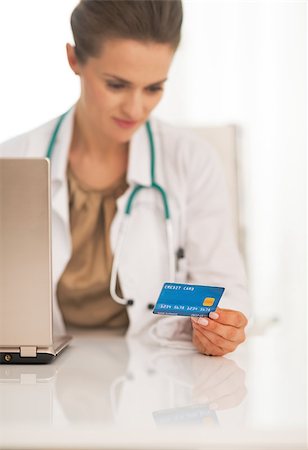 doctor with card - Closeup on doctor woman using credit card Stock Photo - Budget Royalty-Free & Subscription, Code: 400-07748392