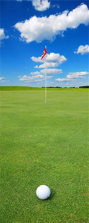 simsearch:400-03975619,k - Golf ball in front of a flag on the green Stock Photo - Budget Royalty-Free & Subscription, Code: 400-07748515