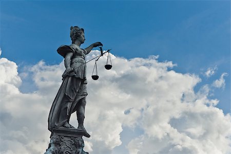 Statue of Justice with sword and scales in front of a blue cloudy sky Stock Photo - Budget Royalty-Free & Subscription, Code: 400-07754704