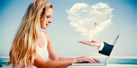 simsearch:400-07664794,k - Composite image of pretty blonde using her laptop at the beach with heart cloud and hand Stock Photo - Budget Royalty-Free & Subscription, Code: 400-07755114