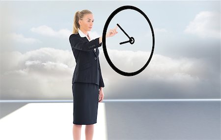 reloj digital - Composite image of businesswoman pointing to a clock Foto de stock - Super Valor sin royalties y Suscripción, Código: 400-07755156