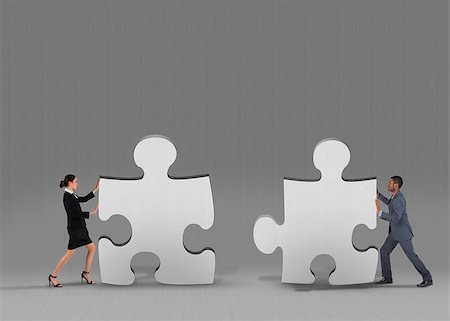 simsearch:400-07665425,k - Composite image of business team standing and pushing against grey jigsaw pieces Stockbilder - Microstock & Abonnement, Bildnummer: 400-07755233