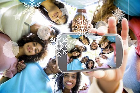 Hand holding smartphone showing friends forming huddle Stock Photo - Budget Royalty-Free & Subscription, Code: 400-07755628