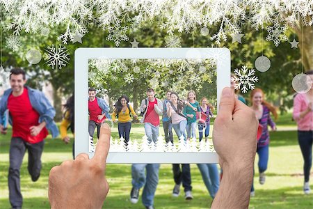 Hand holding tablet pc against college students running in the park Stock Photo - Budget Royalty-Free & Subscription, Code: 400-07755621