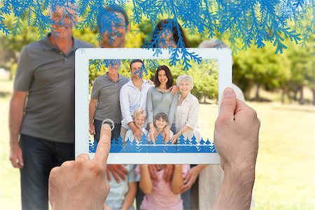 family with tablet in the park - Hands holding tablet pc against family standing in the park Photographie de stock - Aubaine LD & Abonnement, Code: 400-07755645