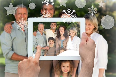 family with tablet in the park - Hands holding tablet pc against family looking at the camera in the park Stock Photo - Budget Royalty-Free & Subscription, Code: 400-07755648