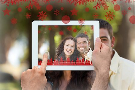 family with tablet in the park - Hands holding tablet pc against couple sitting in the garden Stock Photo - Budget Royalty-Free & Subscription, Code: 400-07755649