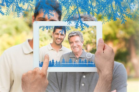 family with tablet in the park - Hands holding tablet pc against father with his son looking at the camera Stock Photo - Budget Royalty-Free & Subscription, Code: 400-07755655