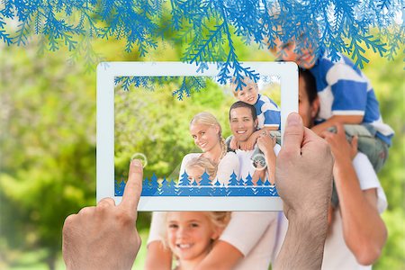 family with tablet in the park - Hands holding tablet pc against happy family in the park Photographie de stock - Aubaine LD & Abonnement, Code: 400-07755650