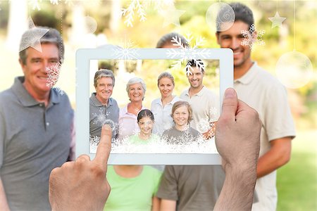 family with tablet in the park - Hands holding tablet pc against family in the park Stock Photo - Budget Royalty-Free & Subscription, Code: 400-07755652