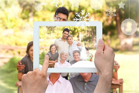 family with tablet in the park - Hands holding tablet pc against family in the park Stock Photo - Budget Royalty-Free & Subscription, Code: 400-07755653