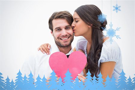 simsearch:400-07957805,k - Pretty brunette giving boyfriend a kiss and her heart against snowflakes and fir trees in blue Photographie de stock - Aubaine LD & Abonnement, Code: 400-07755824