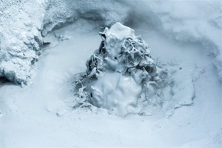 Hot boiling mud at fumarole is bubbling and exploding at mudpots, Hverir - Icelnad. When photographed at high speed nice sculptures could be seen Fotografie stock - Microstock e Abbonamento, Codice: 400-07756747