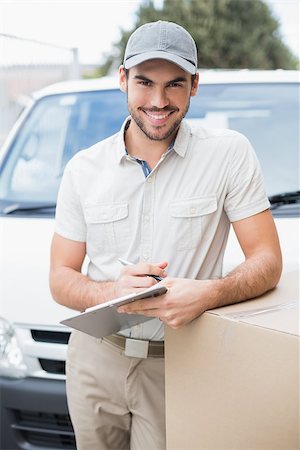 delivery person (male) - Delivery driver smiling at camera by his van outside the warehouse Stock Photo - Budget Royalty-Free & Subscription, Code: 400-07750325