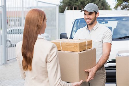 packages on loading dock - Delivery driver passing parcels to happy customer outside the warehouse Stock Photo - Budget Royalty-Free & Subscription, Code: 400-07750336