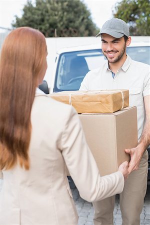 packages on loading dock - Delivery driver passing parcels to happy customer outside the warehouse Stock Photo - Budget Royalty-Free & Subscription, Code: 400-07750337