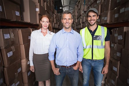 simsearch:400-07750413,k - Warehouse team smiling at camera in a large warehouse Photographie de stock - Aubaine LD & Abonnement, Code: 400-07750387