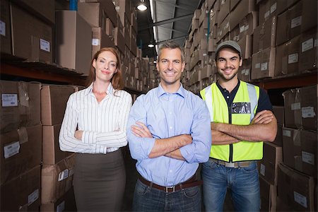 simsearch:400-07750413,k - Warehouse team smiling at camera in a large warehouse Photographie de stock - Aubaine LD & Abonnement, Code: 400-07750388