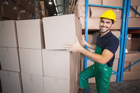 Warehouse worker loading up a pallet in a large warehouse Stock Photo - Budget Royalty-Free & Subscription, Code: 400-07750444