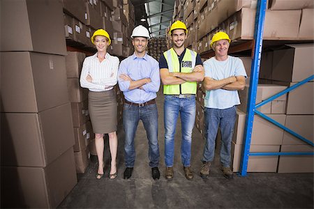 simsearch:400-07750413,k - Warehouse team smiling at camera in a large warehouse Photographie de stock - Aubaine LD & Abonnement, Code: 400-07750469