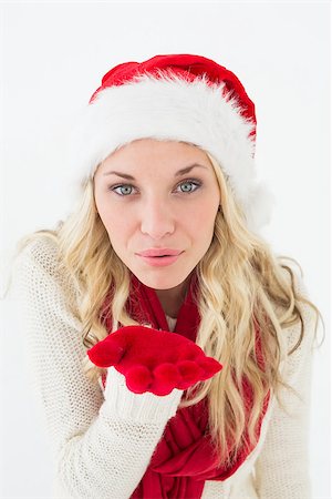 Portrait of young woman wearing santa hat as she blows kiss over white background Stock Photo - Budget Royalty-Free & Subscription, Code: 400-07750544
