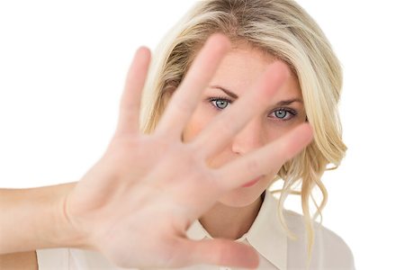 simsearch:400-06635276,k - Close up portrait of young woman signals stop over white background Photographie de stock - Aubaine LD & Abonnement, Code: 400-07750600