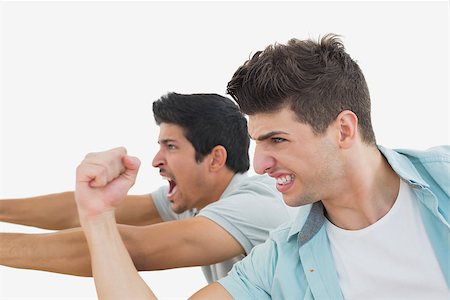 sports fan watching a game on tv - Side view of two excited soccer fans over white background Stock Photo - Budget Royalty-Free & Subscription, Code: 400-07750636