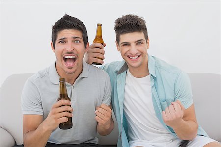 sports fan watching a game on tv - Portrait of two excited soccer fans watching tv Stock Photo - Budget Royalty-Free & Subscription, Code: 400-07750638