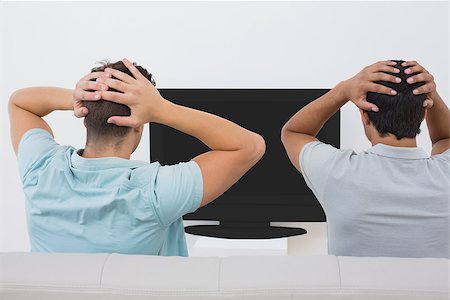 sports fan watching a game on tv - Rear view of two tensed soccer fans watching tv Stock Photo - Budget Royalty-Free & Subscription, Code: 400-07750633