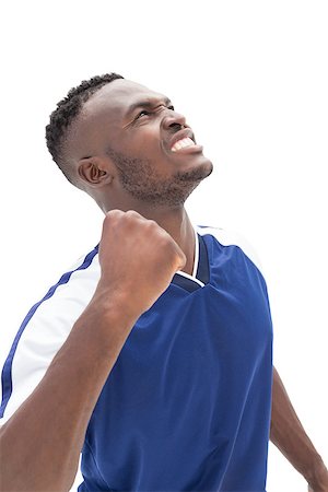 simsearch:400-07833287,k - Sporty football player looking up over white background Fotografie stock - Microstock e Abbonamento, Codice: 400-07750646