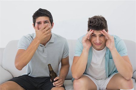 sports fan watching a game on tv - Portrait of two disappointed soccer fans watching tv Stock Photo - Budget Royalty-Free & Subscription, Code: 400-07750640