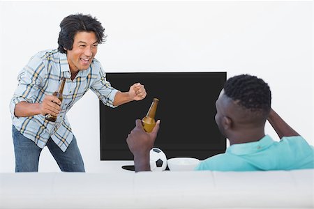 people cheering excite at home - Two excited soccer fans watching tv Stock Photo - Budget Royalty-Free & Subscription, Code: 400-07750694