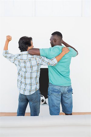 soccer home friends - Rear view of two excited soccer fans watching tv Stock Photo - Budget Royalty-Free & Subscription, Code: 400-07750696