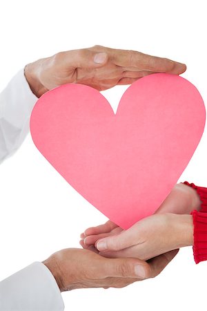 Close up of hands holding heart over white background Stock Photo - Budget Royalty-Free & Subscription, Code: 400-07750725