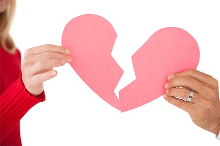 Close up of hands holding two halves of broken heart over white background Stock Photo - Budget Royalty-Free & Subscription, Code: 400-07750733