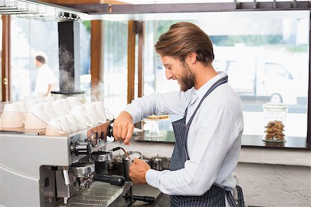 Handsome barista making a cup of coffee at the coffee shop Stock Photo - Budget Royalty-Free & Subscription, Code: 400-07750829