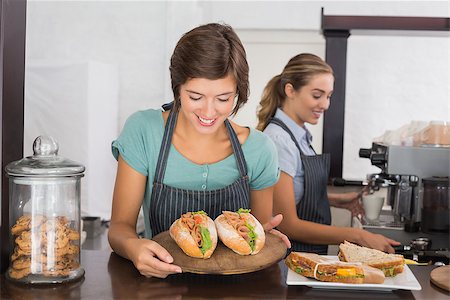 simsearch:400-06917365,k - Pretty waitresses working with a smile at the coffee shop Stock Photo - Budget Royalty-Free & Subscription, Code: 400-07750916