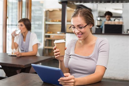 simsearch:400-07664794,k - Pretty blonde enjoying a coffee using tablet pc at the coffee shop Stock Photo - Budget Royalty-Free & Subscription, Code: 400-07751056