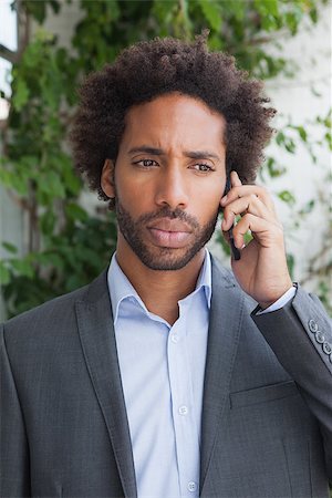 simsearch:400-07139155,k - Handsome businessman on the phone on a sunny day Stock Photo - Budget Royalty-Free & Subscription, Code: 400-07751285