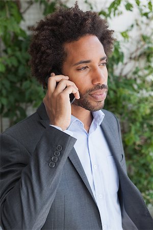 simsearch:400-07139155,k - Handsome businessman on the phone on a sunny day Stock Photo - Budget Royalty-Free & Subscription, Code: 400-07751286