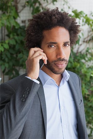 simsearch:400-07139155,k - Handsome businessman on the phone on a sunny day Stock Photo - Budget Royalty-Free & Subscription, Code: 400-07751287