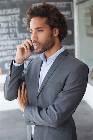 simsearch:400-07139155,k - Handsome businessman on the phone outside at the coffee shop Stock Photo - Budget Royalty-Free & Subscription, Code: 400-07751296